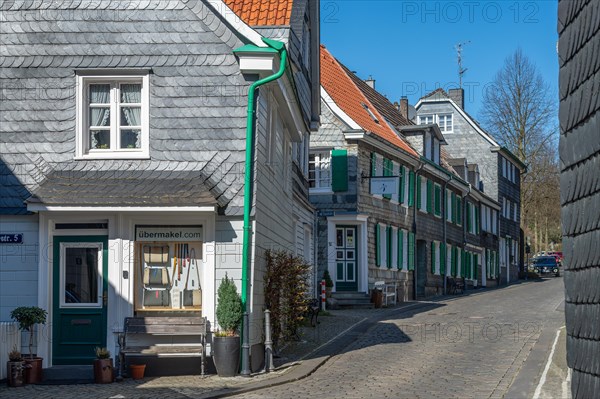 Street view with traditional German half-timbered houses and cobblestones on a sunny day, Graefrath, Solingen, Bergisches Land, North Rhine-Westphalia