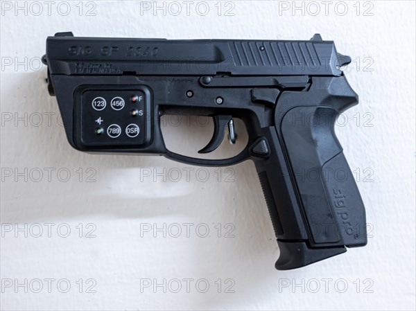 New Modern Handgun SIG SP2340 Prototype with Electronic Combination Lock System Hanging on a Wall in Switzerland