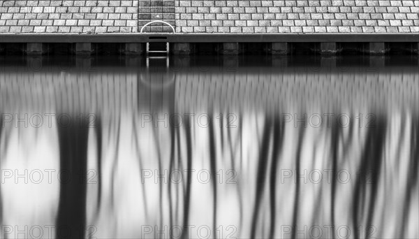 Long exposure, reflection of trees in the water of the Spree, Am Schleusenkanal, Berlin, Germany, Europe