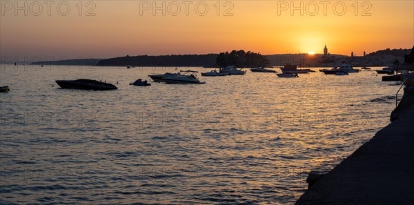Boats anchoring in a bay, silhouette of a church tower, sunset over Rab, panoramic view, town of Rab, island of Rab, Kvarner Gulf Bay, Croatia, Europe