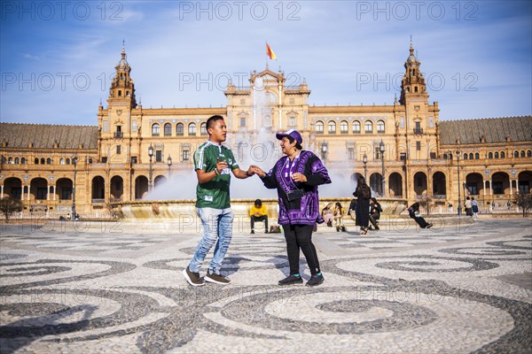 Seville, Spain, March 9, 2022: dancing people in front of the fountain in Plaza de Espana, Seville, Europe