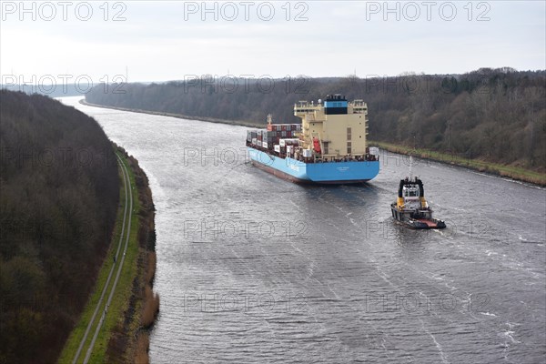 Container ship Laura Maersk is escorted by a tugboat in the Kiel Canal, Kiel Canal