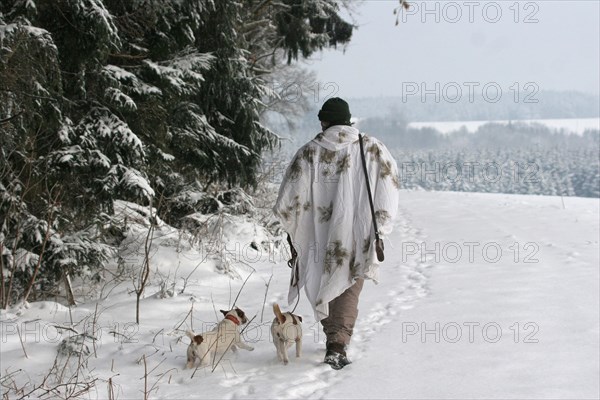 Hunter in winter with snow shirt and Jack Russell Terrier, Allgaeu, Bavaria, Germany, Europe