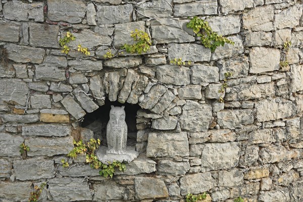 Sculpture of a little owl in a niche of the historic town wall, owl figure, town fortification, Ochsenfurt, Lower Franconia, Franconia, Bavaria, Germany, Europe