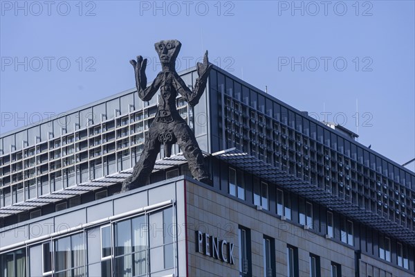 On the acute-angled corner of the building at the junction of Maxstrasse and Ostra-Allee stands a four-metre bronze sculpture of a stick figure created by A. R. Penck, Dresden, Saxony, Germany, Europe