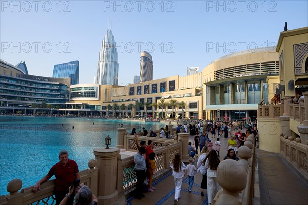 Tourists in front of the skyscraper backdrop at Lake Burj Khalifa. Dubai, United Arab Emirates, Asia