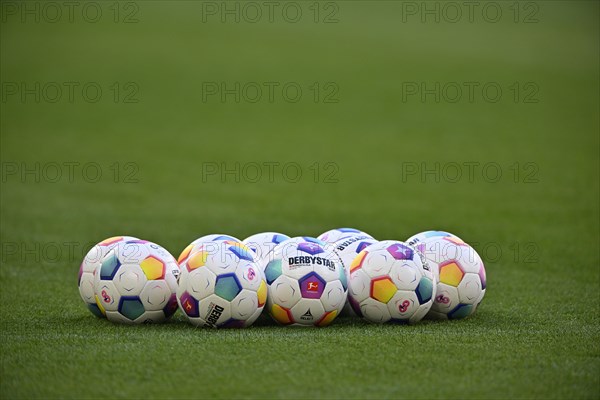 Adidas Derbystar match balls lie on grass, Allianz Arena, Munich, Bavaria, Germany, Europe