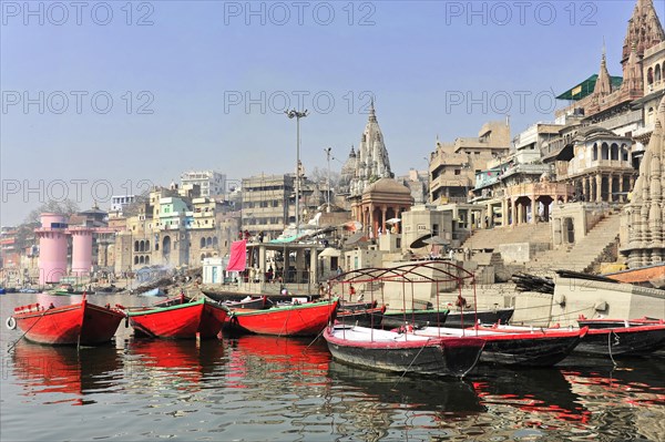 View of the busy river ghats of Varanasi with boats and historical buildings, Varanasi, Uttar Pradesh, India, Asia