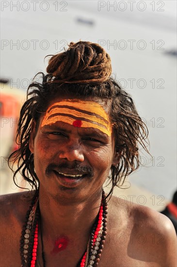 Close-up of a smiling sadhu with traditional painting in Varanasi, Varanasi, Uttar Pradesh, India, Asia