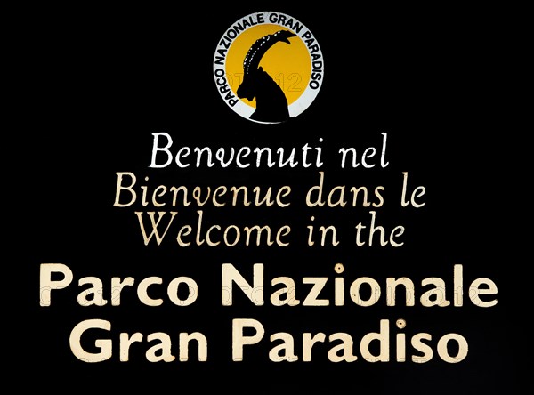 Wooden welcoming board with logo of the Gran Paradiso National Park in the Graian Alps, Italy, Europe
