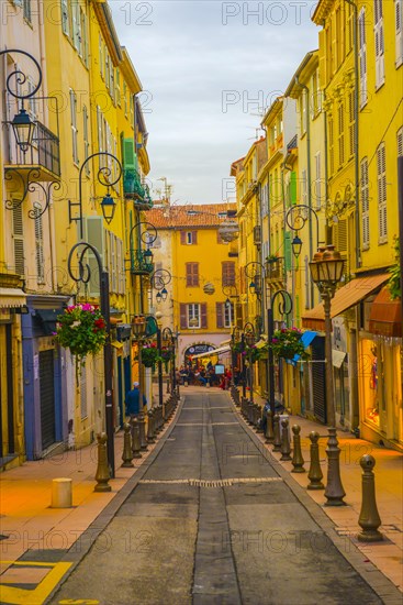 Narrow Street in Old Town with Street Lamps in Menton in Provence-Alpes-Cote d'Azur, France, Europe