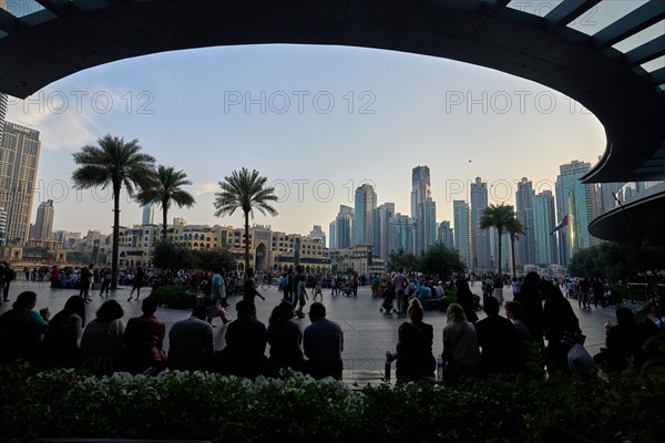 Tourists in front of the skyscraper backdrop at Lake Burj Khalifa. Dubai, United Arab Emirates, Asia