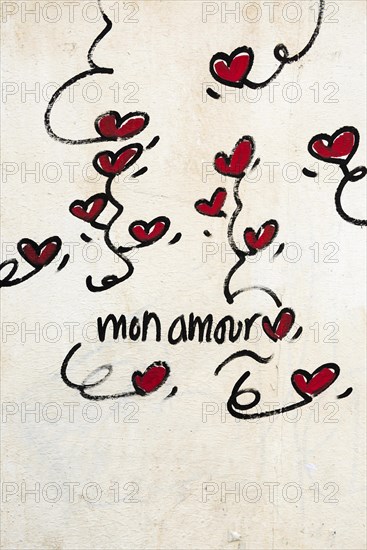 Street art, painted house wall with hearts and lettering on the theme of love, Montmartre, Paris, Ile-de-France, France, Europe