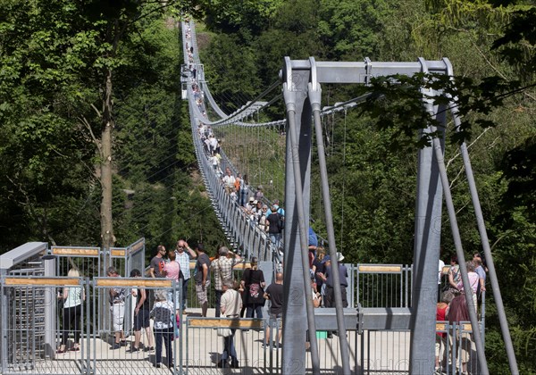 Visitors cross the rope suspension bridge at the Rappbode dam, 483 metres long, 100 metres above the valley floor, Oberharz, 11.06.2017