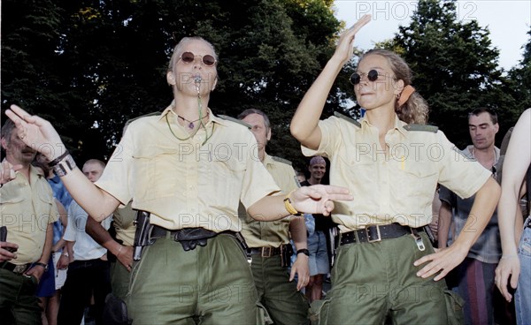 Policewomen of the Berlin police celebrate with techno fans during the Love Parade. Techno music fans celebrate the 9th Love Parade with more than one million visitors in Berlin on 12 July 1997 under the motto Let the sun shine to your heart