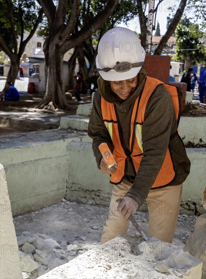 Oaxaca, Mexico, A worker chisels a block of stone to use in repairs on Guadalupe Church, Central America