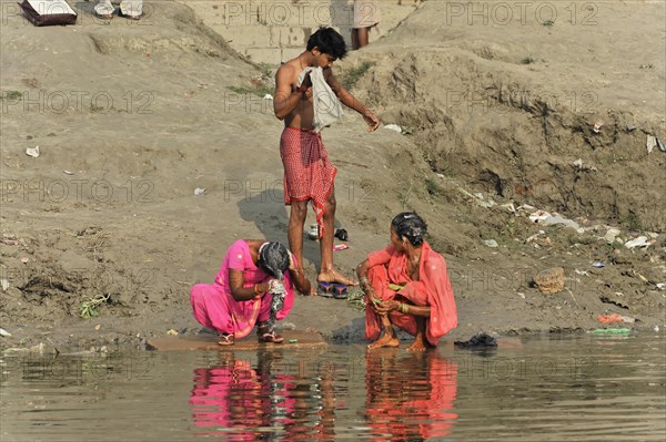 Children and adults washing themselves and their clothes in a river, Varanasi, Uttar Pradesh, India, Asia