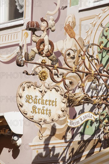 Old, decorated hanging sign of the Kraetz bakery in Ludwigstrasse, Partenkirchen district, Garmisch-Partenkirchen, Werdenfelser Land, Upper Bavaria, Bavaria, Germany, Europe