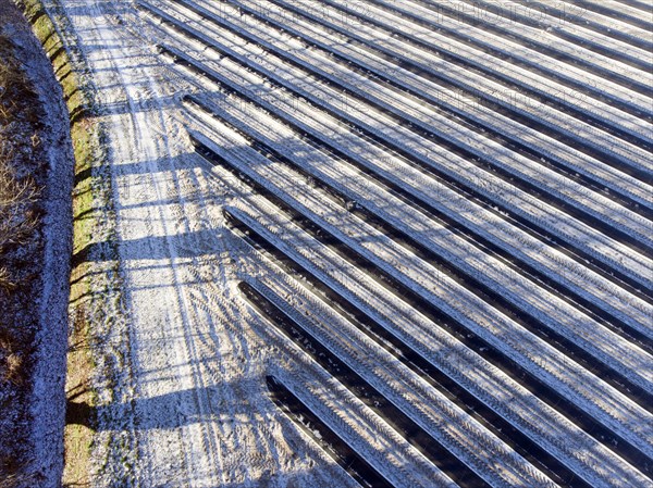An aerial photo shows snow-covered sheets stretched over asparagus fields, 06/01/2017