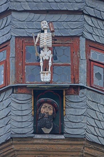 Lancet turret with skeleton and figure, head, window, detail, slate roof, slate slabs, slate shingles, New Town Hall, Ochsenfurt, Lower Franconia, Franconia, Bavaria, Germany, Europe