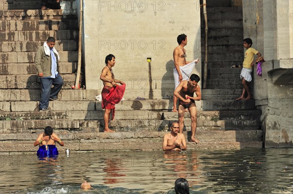 Local people traditionally bathe at the ghats of a river in India, Varanasi, Uttar Pradesh, India, Asia