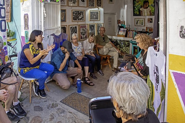 Oaxaca, Mexico, Alejandra Canseco Alhil (left) discusses the 2006 protests in Oaxaca with foreign visitors. She was one of the leaders of the Popular Assembly of the Peoples of Oaxaca (APPO), which took control of the city for several months. She had to flee the city after the government regained control, but now operates an art studio there, Central America