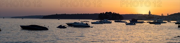 Boats anchoring in a bay, silhouette of a church tower, sunset over Rab, panoramic view, town of Rab, island of Rab, Kvarner Gulf Bay, Croatia, Europe