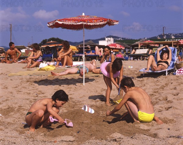 Children playing on the beach in Calella, Costa Brava, Barselona, Catalonia, Spain, Southern Europe. Scanned 6x6 slide, Europe