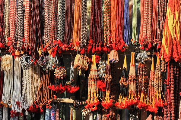 Colourful necklaces and beads hanging in a market stall, presented for sale, Varanasi, Uttar Pradesh, India, Asia