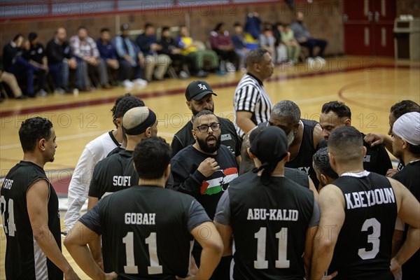 Hamtramck, Michigan USA, 8 March 2024, Arab-Americans from Hamtramck and Dearborn, Michigan faced off in a charity fundraising basketball game and children's tug-of war. The event raised money for charities in Palestine and Yemen. The Hamtramck team talks during a time-out