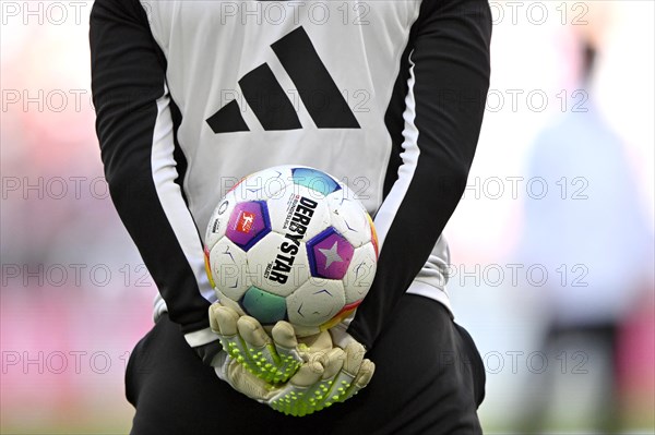 Goalkeeper coach Michael Rechner FC Bayern Munich FCB holds Adidas Derbystar match ball on his back, logo, Allianz Arena, Munich, Bavaria, Germany, Europe