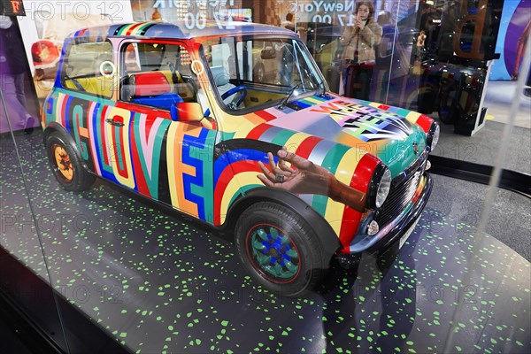 A Mini Cooper with a colourful design and handprints on the bonnet, BMW WELT, Munich, Germany, Europe