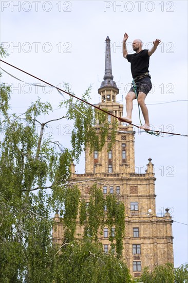 Riga. Alternative cultural centre near the Latvian Academy of Science. Tightrope walker on the slackline, Riga, Latvia, Europe