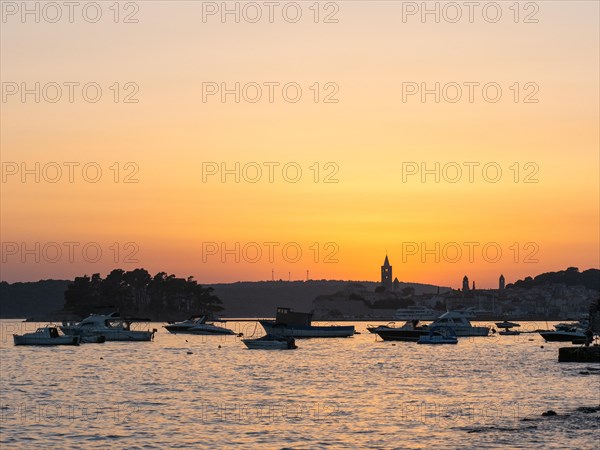 Boats anchoring in a bay, silhouette of church towers, evening mood after sunset over Rab, town of Rab, island of Rab, Kvarner Gulf Bay, Croatia, Europe