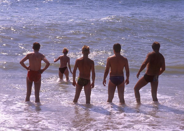 Four men and one woman in the water in Calella, Costa Brava, Barselona, Catalonia, Spain, Southern Europe. Scanned 6x6 slide, Europe