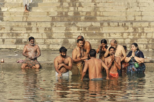 People engage in social interactions while bathing in water, Varanasi, Uttar Pradesh, India, Asia