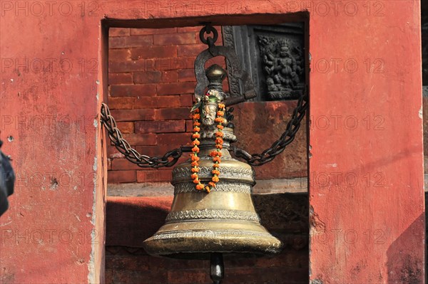 Large bell with floral decorations and religious ornaments on a ghat in Varanasi, Varanasi, Uttar Pradesh, India, Asia