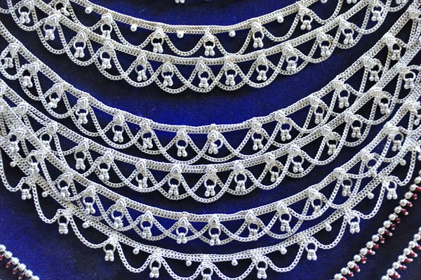Silver jewellery necklaces with detailed patterns on a dark background, Varanasi, Uttar Pradesh, India, Asia