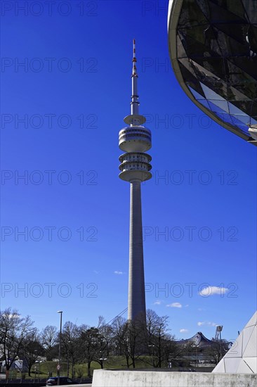 The Olympic Tower in Munich is reflected in the facade of a modern building, BMW WELT, Munich, Germany, Europe