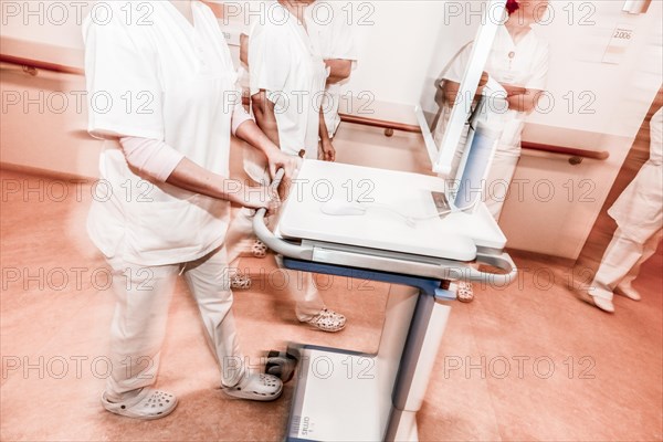 Nurses and care staff walk down a corridor in a hospital in Berlin with the digital patient file, 25/01/2019
