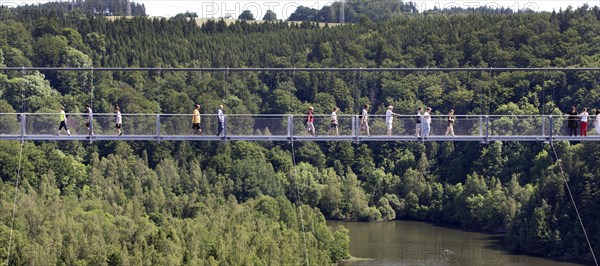 Visitors cross the rope suspension bridge at the Rappbode dam, 483 metres long, 100 metres above the valley floor, Oberharz, 11.06.2017