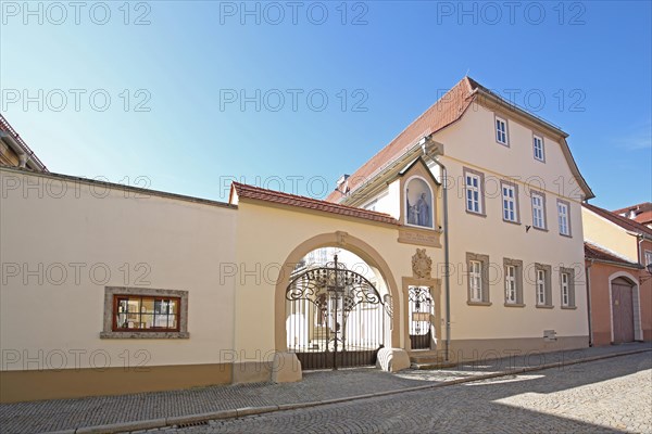 Yellow baroque building with archway and coat of arms built in 1717 by Oberistleutnant Schell, Bahnhofstrasse, Iphofen, Lower Franconia, Franconia, Bavaria, Germany, Europe
