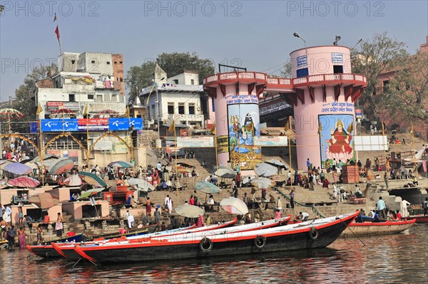 People on boats near ghats with paintings and traditional architecture, Varanasi, Uttar Pradesh, India, Asia