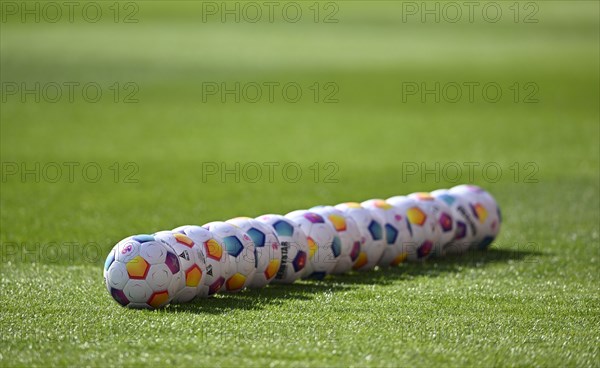 Adidas Derbystar match balls lie in a row on the pitch, Voith-Arena, Heidenheim, Baden-Wuerttemberg, Germany, Europe
