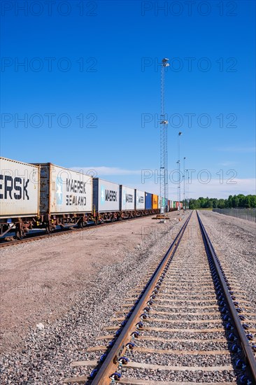 Railway tracks with train wagons with containers in a railway yard
