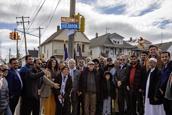 Hamtramck, Michigan USA, 7 March 2024, Community members gather around the street sign after a ceremony symbolically renaming a major street 'Palestine Avenue.' The action is in solidarity with Palestinians in Gaza, where tens of thousands have died in Israel's bombing campaign