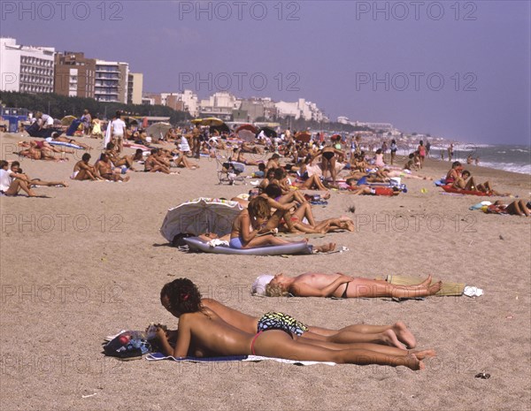 Crowded beach with sunbathers in Calella, Costa Brava, Barselona, Catalonia, Spain, Southern Europe. Scanned 6x6 slide, Europe