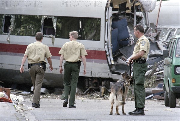 Police officers stand next to a destroyed ICE train carriage on 6 June 1998 in Eschede. 102 people died in the worst Deutsche Bahn train accident