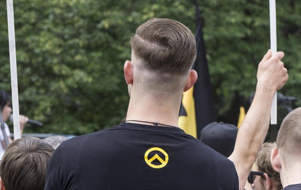 A member of the Identitarian Movement stands among the demonstrators with the Identitarian Movement logo on his shirt. Several hundred supporters of the Identitarian Movement demonstrated in Berlin under the slogan Future Europe - for the defence of our identity, culture and way of life . The right-wing group is being monitored by the Office for the Protection of the Constitution, 17.06.2017