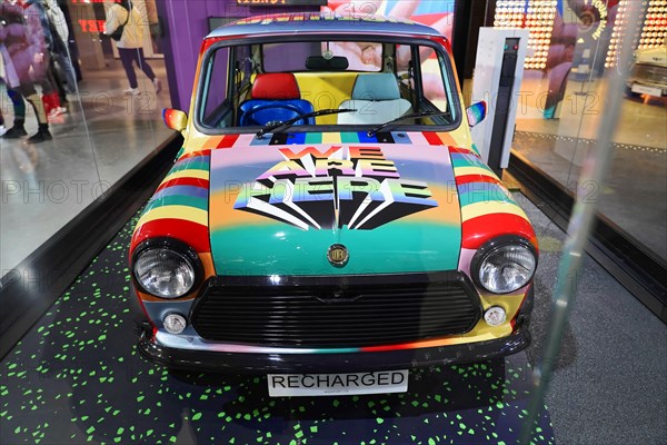 A colourfully designed Mini Cooper stands as an exhibit in a room, BMW WELT, Munich, Germany, Europe